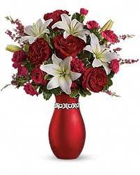 XOXO XOXO - XOXO is shorthand for lots of hugs and kisses, which is what you'll get when you send your lady love this charming 3-in-1 bouquet: spectacular flowers, a stylish red vase she'll treasure and a love bracelet she'll love forever.