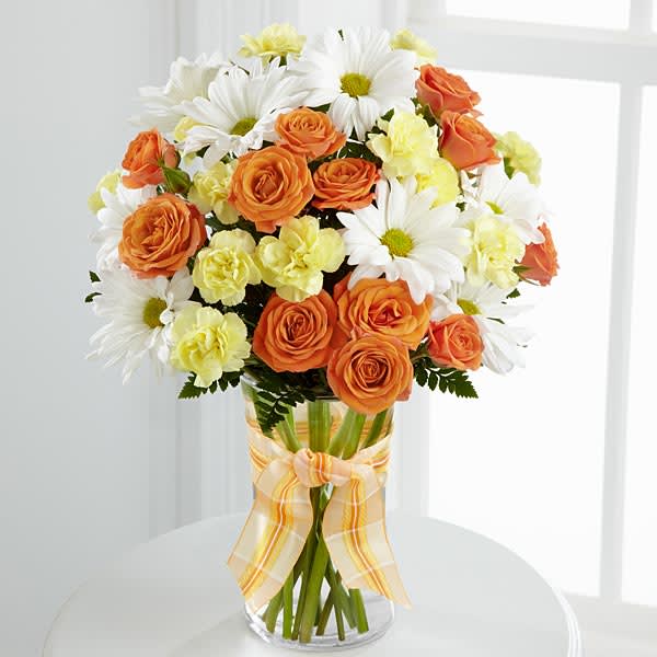 Sweet Splendor Bouquet Sweet Splendor Bouquet - The FTD® Sweet Splendor™ Bouquet radiates cheer and well-wishes with every sun-filled bloom! Orange spray roses yellow mini carnations white traditional daisies and lush greens are brought together in a classic clear glass vase accented with a designer apricot plaid ribbon to create a bouquet set to brighten any day.