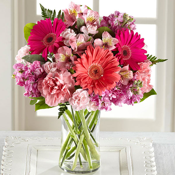 Blushing Beauty Bouquet - Melt their heart with sun-crushed blooms blossoming with an array of color and light your recipient won't soon forget. Coral and hot pink gerbera daisies captivate the eye surrounded by pink Peruvian Lilies pink and hot pink gilly flower pale pink carnations and mini carnations and lush greens situated beautifully in a modern clear glass vase. A simply wonderful way to send your warmest wishes in honor of their birthday as a thank you or get well gift or to shower them with your love and affection! GOOD bouquet includes 13 stems. Approx. 13&quot;H x 10&quot;W. BETTER bouquet includes 17 stems. Approx. 14&quot;H x 11&quot;W. BEST bouquet includes 21 stems. Approx. 15&quot;H x 12&quot;W.
