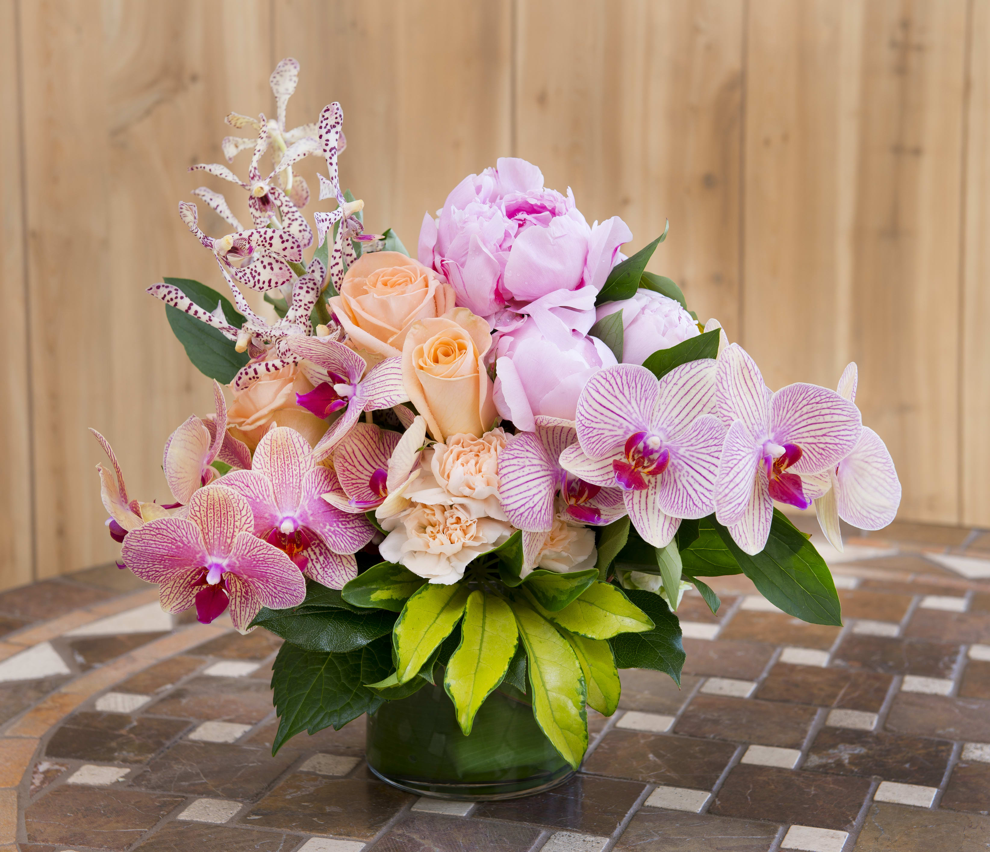 Soft Embrace  - Mixed colored orchids accented with peach roses and light pink peonies. (TEF-004)