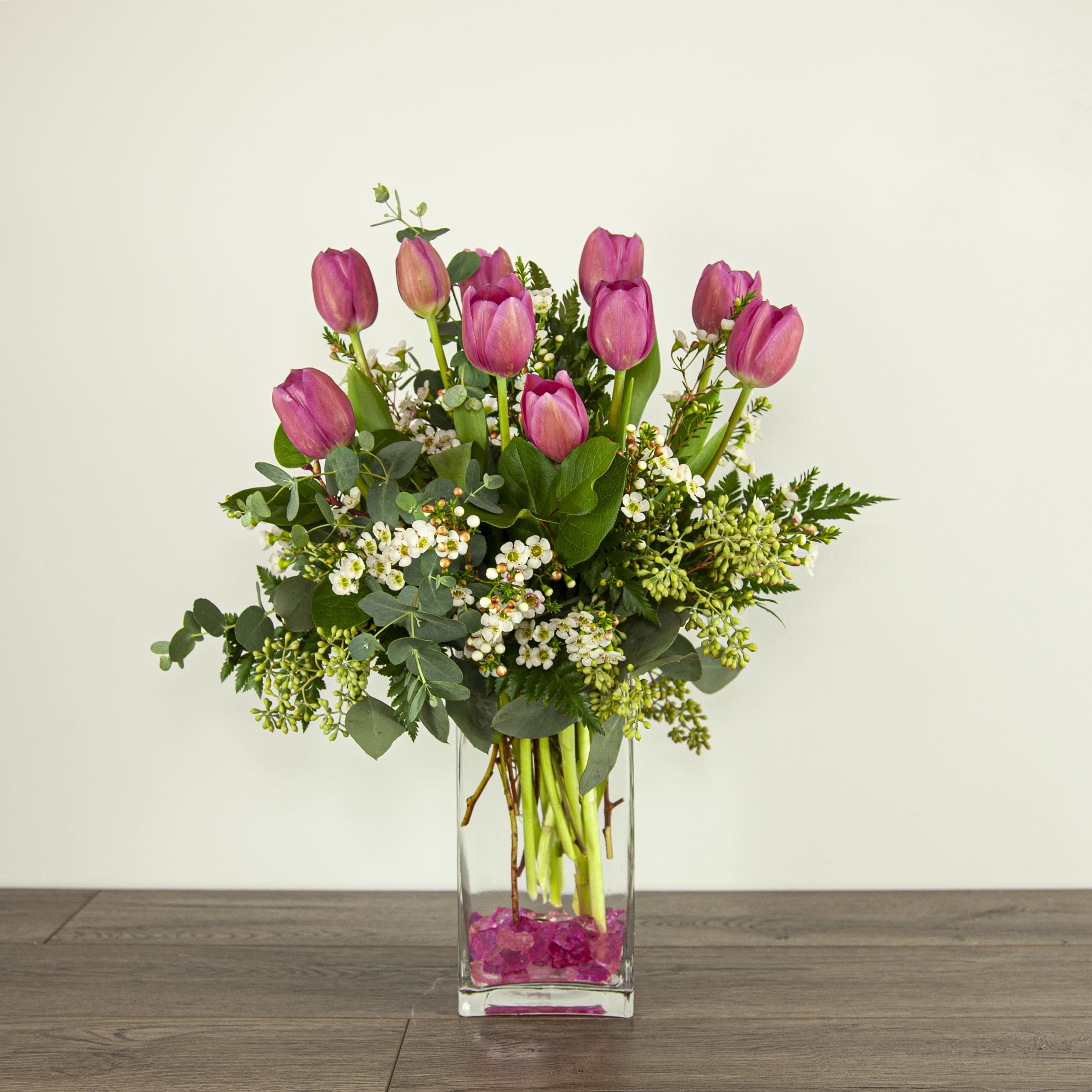 Can't Go Wrong (EXP 38) - Show that special someone you care with these spring seasoned tulips, placed inside a rectangular glass vase. Pink rocks are added to complete the look.  Blooms in this arrangement: - 10 tulips