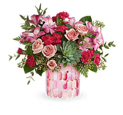 Teleflora's Wild Romance Bouquet - Brimming with stylish Valentine's Day blooms, this unique mosaic vase of swirling stained glass is a glorious gift they'll always treasure. This pretty arrangement features pink spray roses, pink alstroemeria, miniature hot pink carnations, seeded eucalyptus, parvifolia eucalyptus, leatherleaf fern and lemon leaf. Delivered in Teleflora's Precious in Pink cylinder. Orientation: All-Around
