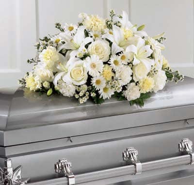 Sweet Peace Casket Spray - Designed for a child's service, this pure white casket spray reflects the innocence of a child. This spray is comprised of all white roses, carnations, lilies, poms and mini Gerbera daisies.