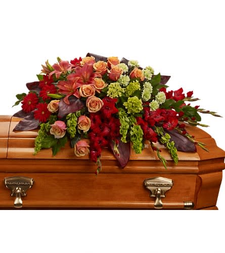 A Fond Farewell Casket Spray A Fond Farewell Casket Spray - An overflowing of love and respect is joyfully expressed in this truly magnificent casket spray of orange roses and lilies and other brilliant blooms. The magnificent arrangement includes green miniature hydrangea orange roses dark orange asiatic lilies red gerberas red gladioli green carnations and bells of Ireland accented with assorted greenery.Approximately 44" W x 25" H Orientation: N/A As Shown : T271-3A