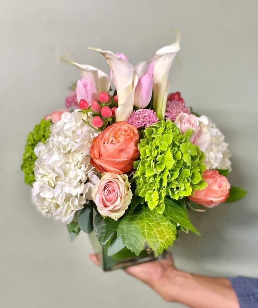 Calla Lillies Dream Calla Lillies Dream - Arrangement includes, hydrangeas, roses, white calla lilies, coffee beans etc all hand arranged in glass square vase.