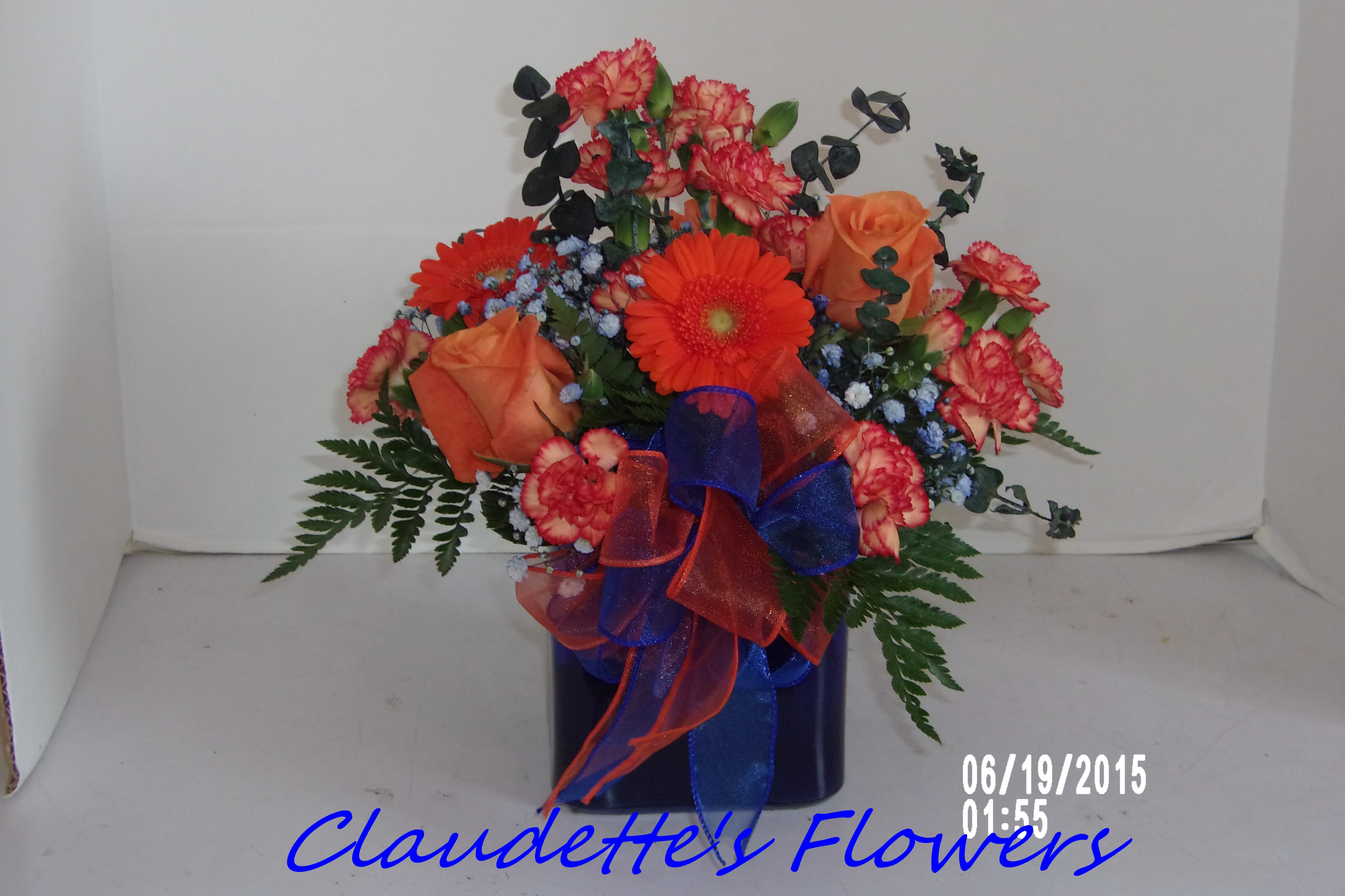 Go Syracuse University - oranger gerbera's and orange mini carns make up this blue cube with a stunning blue bow.
