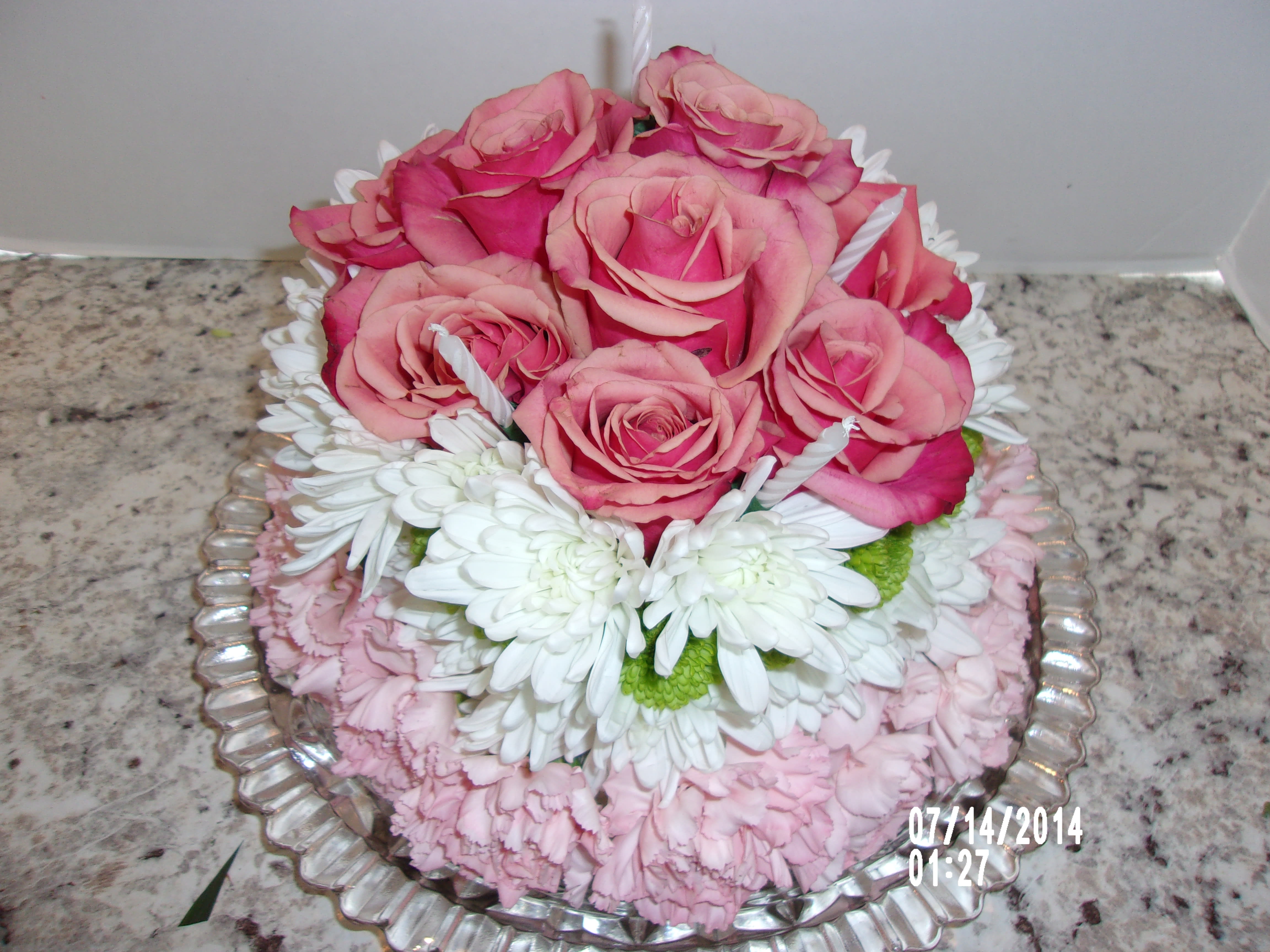 flower cake - this is a cake made completely out of carnations daisies and roses.  We can add candles if you wish.  Just let us know.