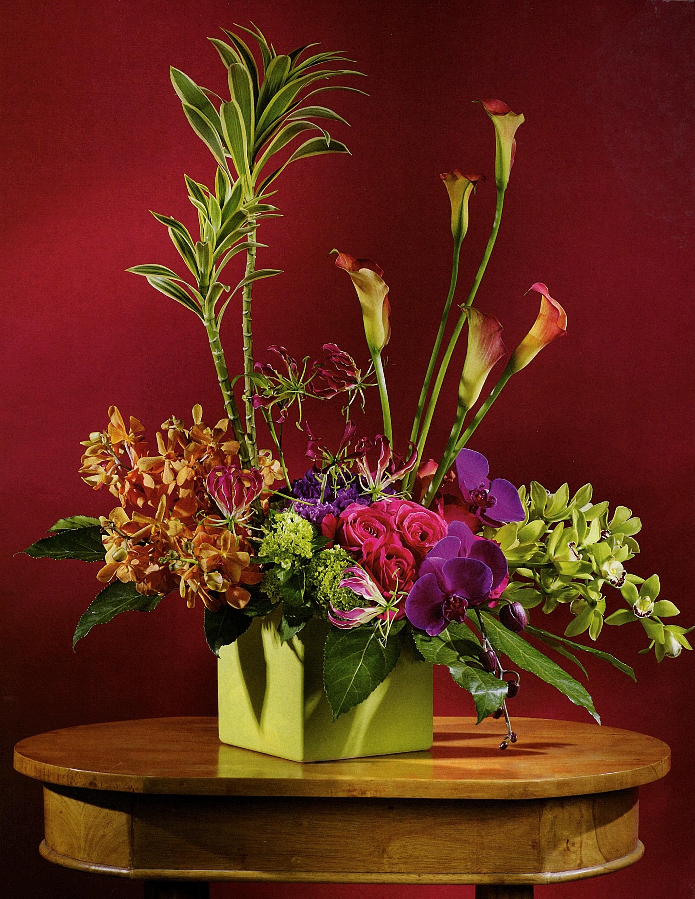 Tropical Getaway Tropical Getaway - One look and they'll feel like they are in a tropical paradise, exotic blooms include orchids, calla lilies, roses and more in a dramatic high style design