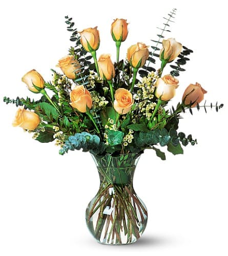 A Dozen Pale Peach Roses - A dozen pale peach roses with eucalyptus and waxflower in a classic glass vase