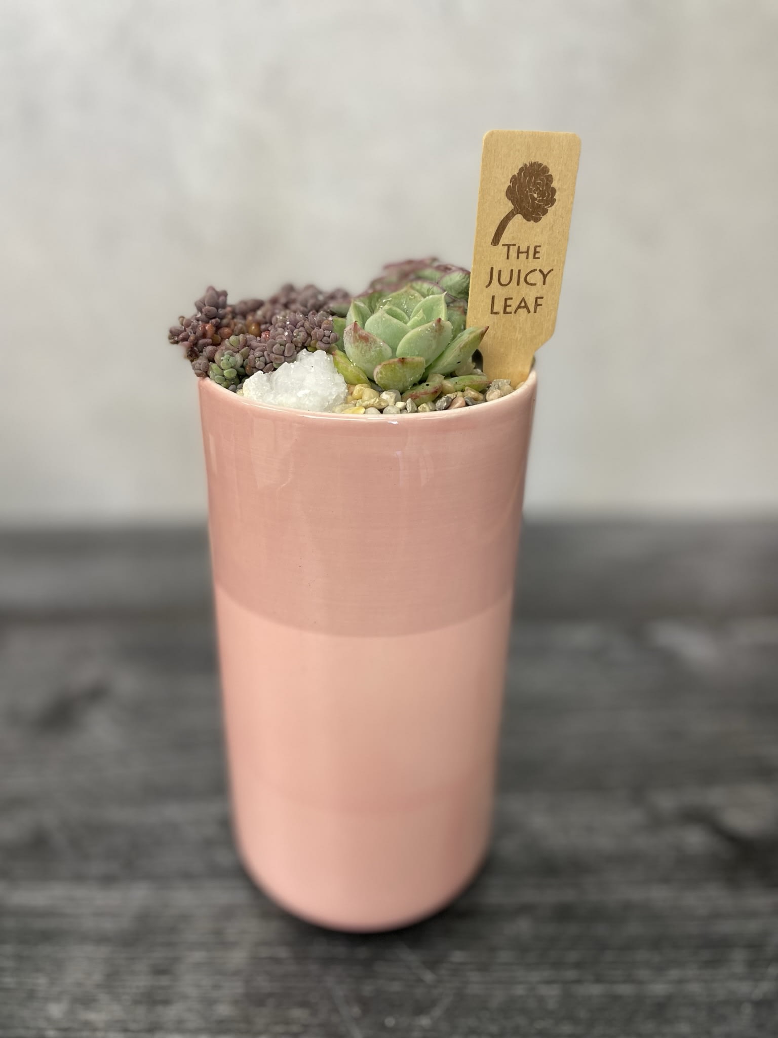 Tall Love - A Beautiful talk cylindrical pot with different shades of pink with succulents in it.