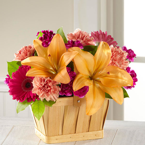The FTD Happiness Bouquet - Shine a light and send happy wishes to your recipient today captured in each sunlit bloom of this simply beautiful flower bouquet. Bi-colored yellow and orange roses mingle with peach Asiatic Lilies hot pink gerbera daisies orange carnations purple mini carnations and lush greens arranged to perfection in a rectangular woodchip basket to create a truly cheerful moment. A great way to say happy birthday get well or thank you! GOOD bouquet includes 11 stems. Approx. 9&quot;H x 10&quot;W. BETTER bouquet includes 15 stems. Approx. 10&quot;H x 11&quot;W. BEST bouquet includes 18 stems. Approx. 11&quot;H x 13&quot;W.  **Lilies may arrive in bud stage.**