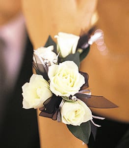 5 White Mini Roses Wristlet 5 White Mini Roses Wristlet - Black, white and silver together are dark, light and lovely. Five pure white roses pop when set against silver and black ribbons and silver beads.