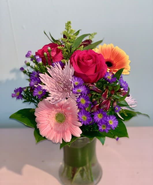 Spring Beauty - A bright, colorful mid-size arrangement sure to brighten anyones day! (Colors of Gerbers may vary)