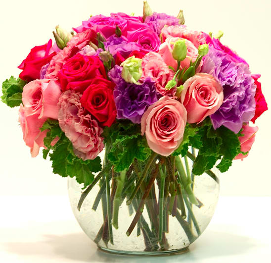 Potpourri of Roses - This arrangement is made with three dozen multicolored Roses and other seasonal flowers  freshly cut with greens in a glass vase ... simply beautiful