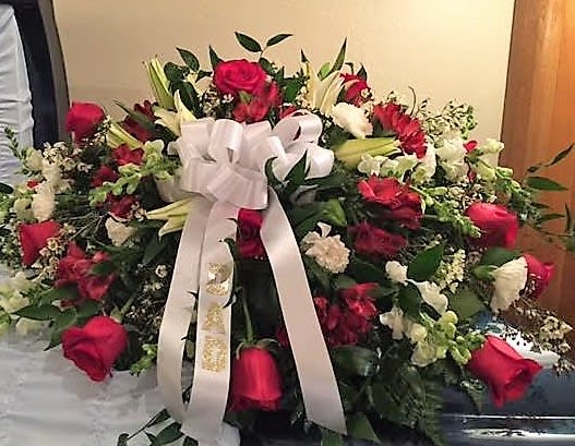 red and white casket piece - red roses, white lily's, white snaps, white Monte and red alstro