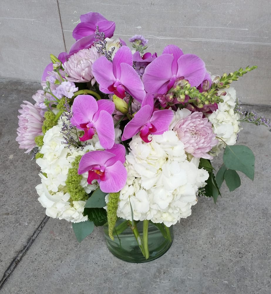 So Pretty in Pink - This is one design that is all about these sumptuous Phalaenopsis Orchids. If your special recipient here in Miami is a real Orchid lover, this design may just be perfect. Hydrangea and a variety of other seasonal specialty blooms all accent these beautiful Orchids to perfection. This is one design that not only has an exotic presence but also is a nice long-lasting bouquet.  If you would like to send this lovely to a special someone here in the greater Miami area, we would love to do that for you. We deliver flowers and smiles throughout the greater Miami metro area every day. So if you do happen to be looking for a great local Florist in Miami, we would love to be your favorite neighborhood Florist.