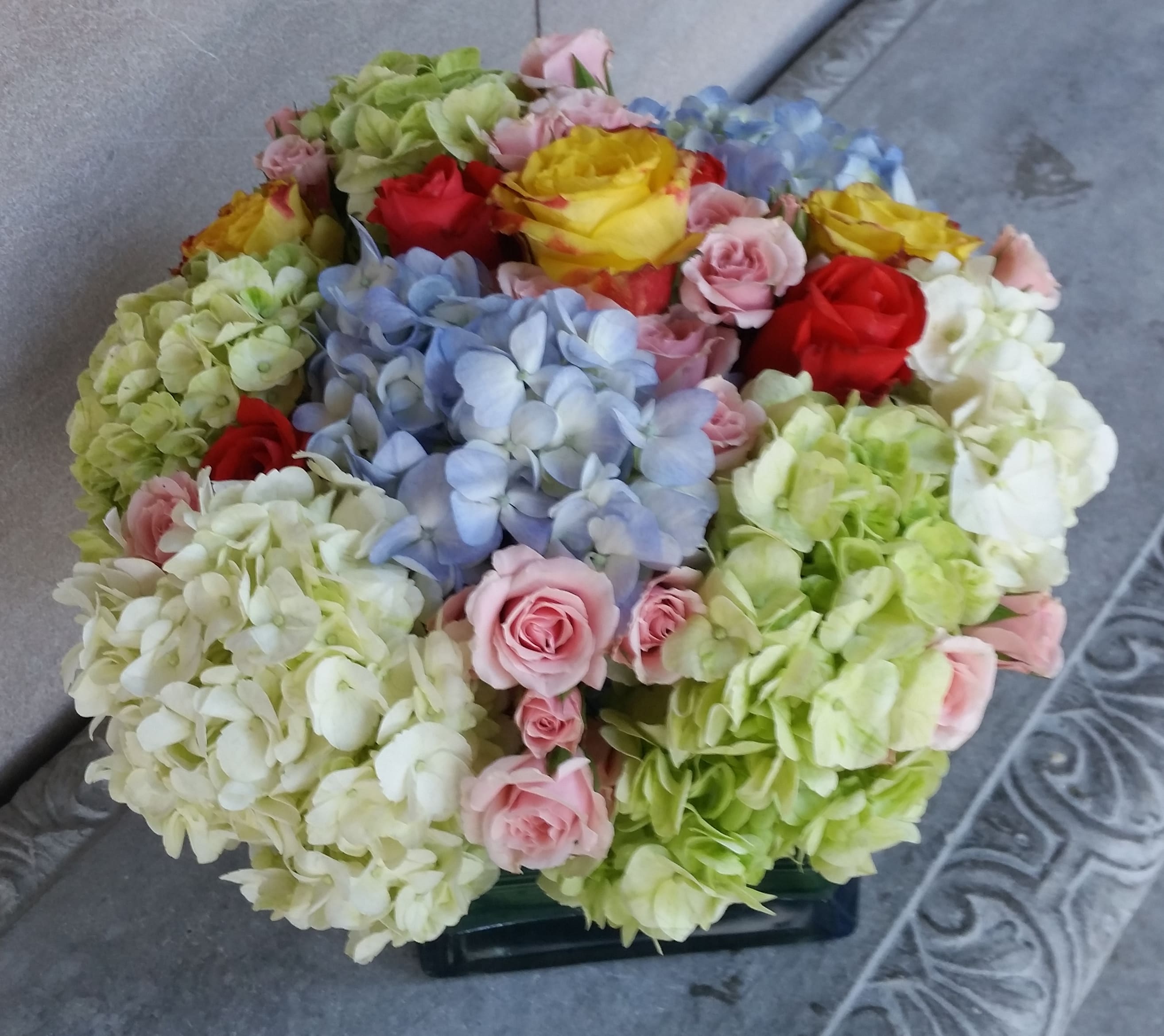 Colorful Pastels - In our 'Colorful Pastels', we are celebrating everything we love about Hydrangeas with a beautiful pairing of lush Roses. Hydrangea is one of those flowers that naturally grow in a variety of soft fluffy pastel shades. Hydrangea in lavenders, blues, pinks, and greens are all nestling among a beautiful collection of Roses in the same soft pastels.  If you have a flower lover in your life that gravitates to anything in pastel colors, they will love this bouquet.  Even though we do flowers for so many different large events here in Miami, Florida. We love the opportunity to create special bouquets like this one for our local clients. Being able to get to know our regular customers enables us to create those special relationships with those who share our crazy love of flowers. Can we deliver some crazy &quot;Flower Love&quot; for you today?