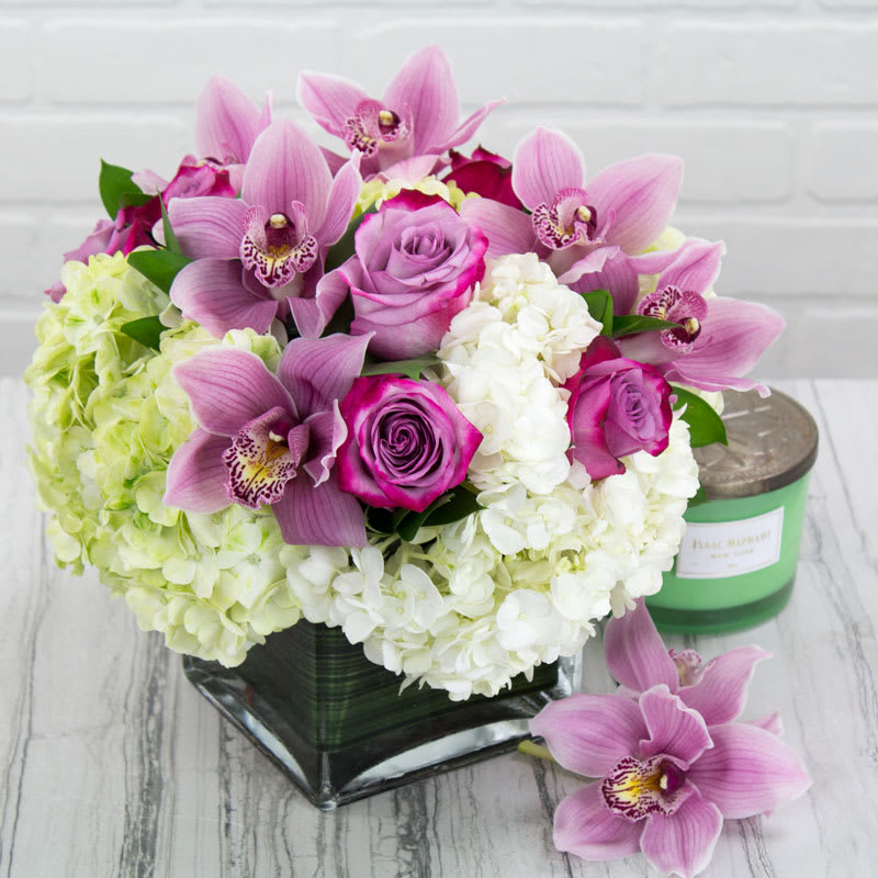 Lovely in Lavender Lovely in Lavender - My Sherman Oaks Florists presentThis arrangement has the dimensions of: a head of 14" and a height of 12'. The design features a mix of antique green and brilliant white Hydrangeas, chic Cymbidium Orchids and tucked lavender Roses to give it that modern texture with those conventional colors. Perfectly priced, it's a wonder your still reading this ! (Standard as Shown)
