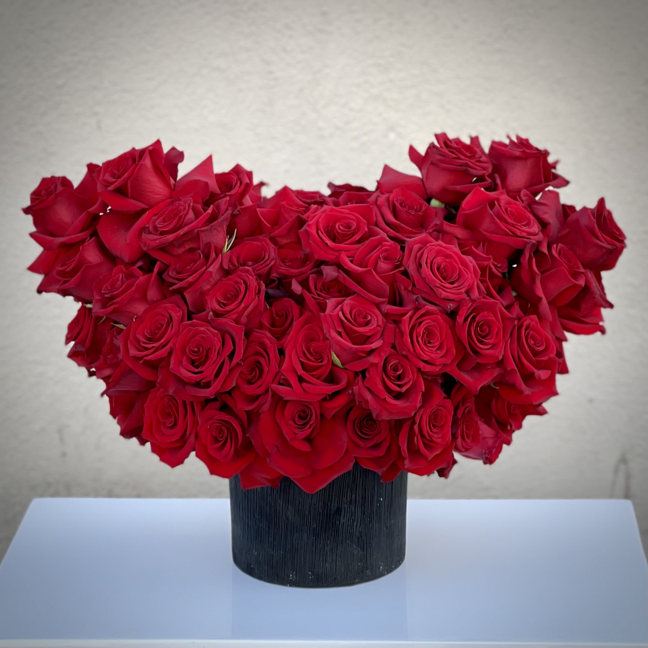 With all my heart With all my heart - This arrangement features over 100 blooms of red roses.