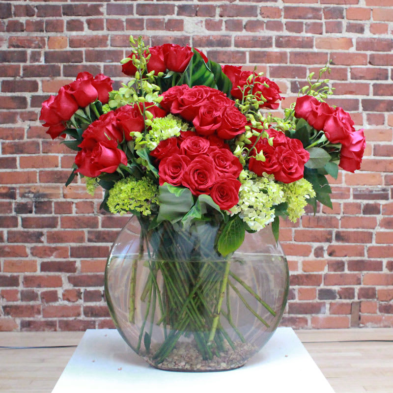100 Long Stem Red Roses wiht Orchids 100 Long Stem Red Roses wiht Orchids - 100 long stem red roses with hydrangeas and Orchids in a clear vase Deluxe: 10 dozen Premium 200 Long Stem Red Roses