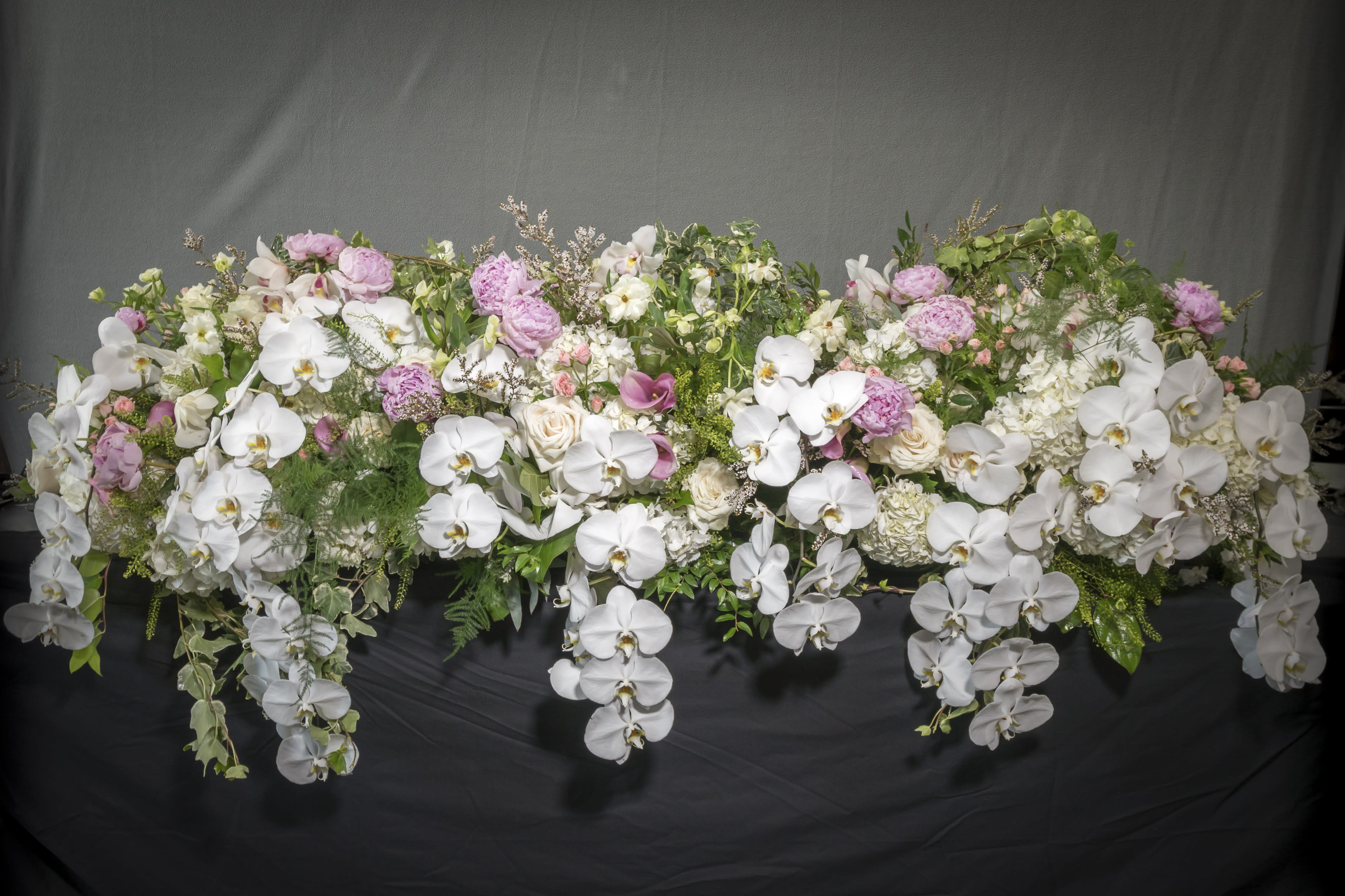 Casket Floral - Floral for the casket decorated in seasonal white blooms. An overflowing of love and respect in this floral arrangement.