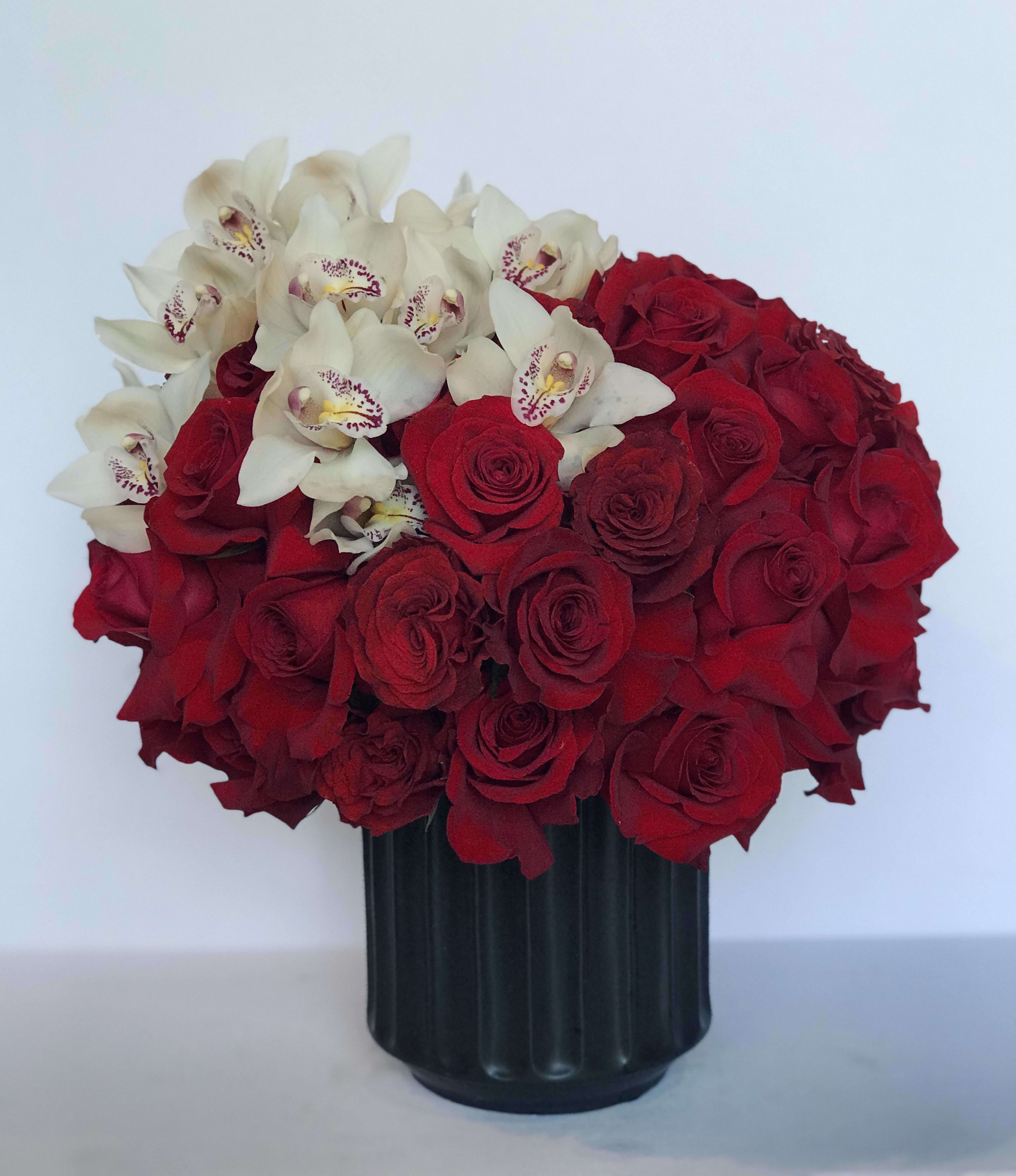 Forever Orchids and Roses Forever Orchids and Roses - There's no better way to show your love than with this stunning arrangement of red roses and white cymbidium orchids.