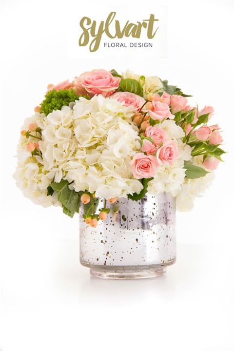 Cluster of Love Cluster of Love - This lovely combination of white hydrangea, pink spray roses, hypericum, kale in a silver glass vase. (Florals and container might vary due to availability.) Note: If you would like to change floral color, please add your request in the note section when placing your order.