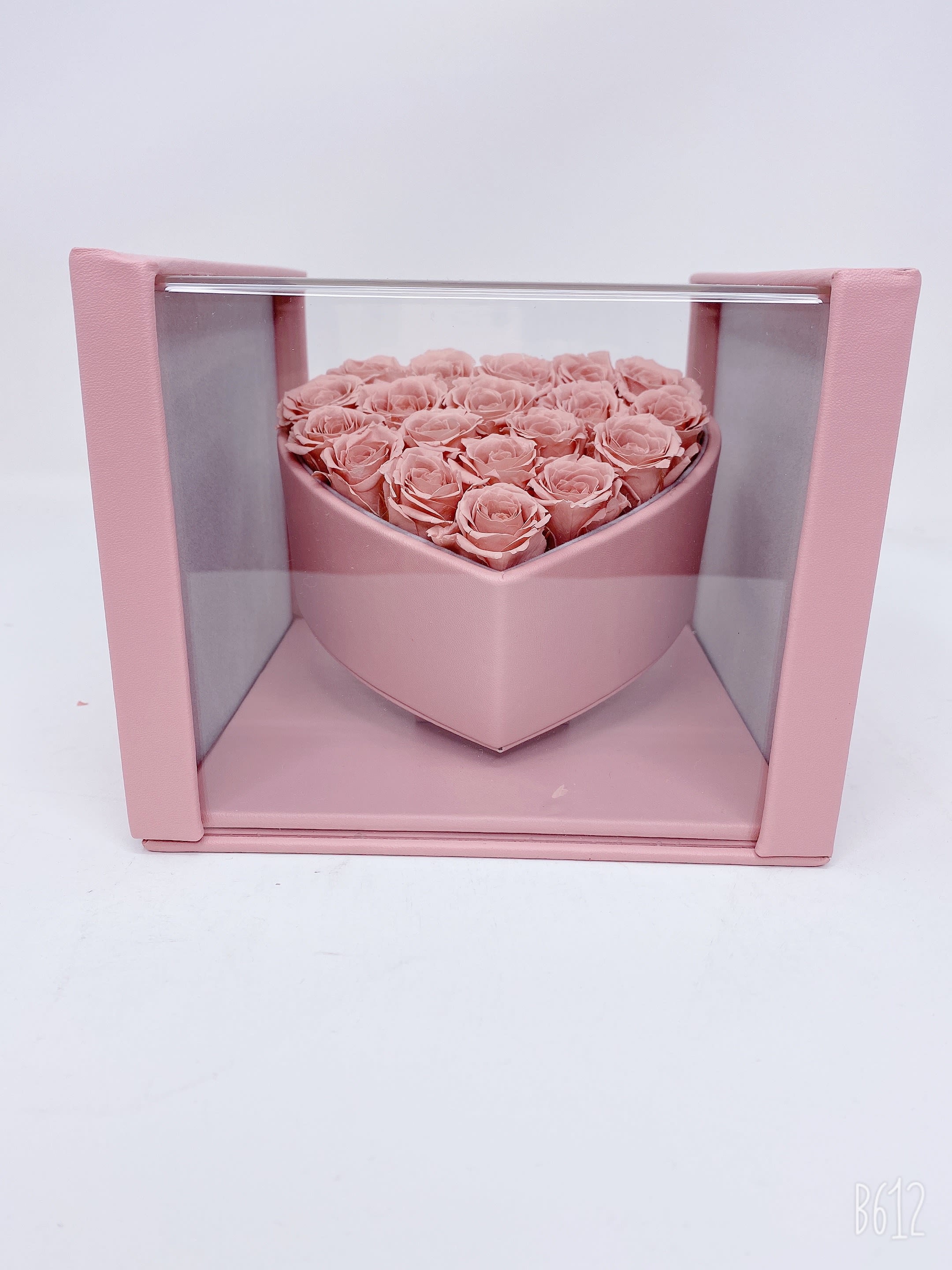Heart Box with Pink Roses - This timeless arrangement is a part of our Eternity Collection and features real flowers that last up to three years set in our hand-stitched vegan leather Heart Box.    **Please note that variations will occur since all of our arrangements are handmade by our in-house designers.**    Caring for Preserved Roses:  1. Do not water the arrangement 2. Keep the arrangement indoors 3. Keep the arrangement out of direct sunlight 3. Keep the arrangement in a cool, dry place 4. Do not crush, press, or fold the petals.