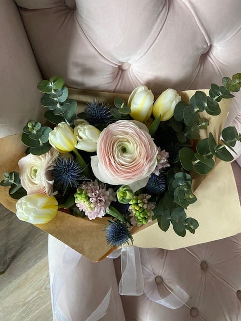 The Petite Bouquet The Petite Bouquet - The Petite Bouquet is made up of blush Italian ranunculus, Dutch Tulips, Hyacinth, Thistle, and Eucalyptus.