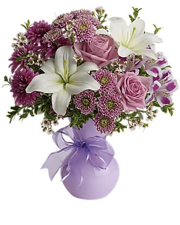 Teleflora's Precious in Purple - If you want to impress someone send elegant flowers in a soft lavender vase accented with a lavender ribbon. Warm rich dramatic it's the kind of gift that says &quot;You're special. And so am I.&quot;