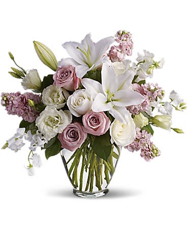 Isn't It Romantic - Tonight will certainly be romantic if you send this classic arrangement today! Beautiful hues and gorgeous blossoms will deliver your love.