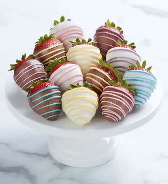 Special Delivery Dipped Strawberries - Welcome a new bundle of joy with a bundle of sweet decadent treats.  A dozen, dipped strawberries, drizzled and decorated to help celebrate a baby boy or girl. Twins? Send two dozen!  One dozen strawberries: 6 dipped in milk chocolaty confection with pastel chocolaty drizzle; 6 dipped in white chocolaty confection with pastel chocolaty drizzle; drizzle colors may vary Berries are dipped in delicious milk chocolaty confection Serves approx. 2 people; 140g per serving May be delivered from a local shop or shipped in a gift box. See Details Allergy Warning: Products may contain peanuts and/or tree nuts. We recommend that you take the necessary precautions based on any related allergies