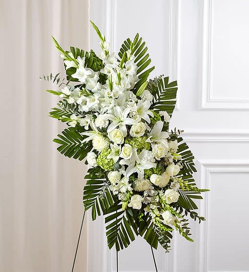 White Rose and Lily Standing Spray - Our contemporary standing sympathy spray fills a room the way the departed filled hearts with love. Asymmetrically arranged with fresh white roses, lilies and carnations, green hydrangeas, this is a grand tribute to perfectly express your wishes for peace, serenity and hope.