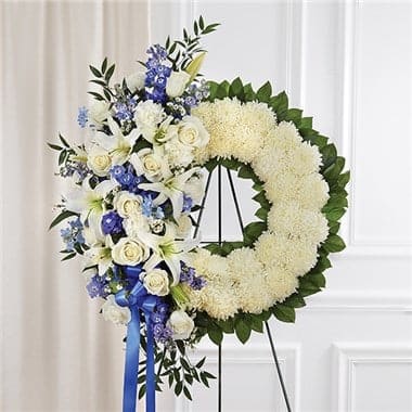 Serene Blessings™ Standing Wreath- Blue & White Serene Blessings™ Standing Wreath- Blue & White - Helping someone find peace after the loss of a loved one can be difficult. If you want to offer your condolences through flowers, our timeless standing wreath in blue and white is a beautiful choice. Artistically handcrafted by our expert local florists with a mix of crisp white blooms and blue delphinium for a lush, full presentation, this grand tribute helps you express all the love and support you have in your heart.