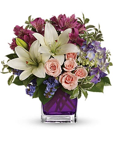 Teleflora's Garden Romance - Hello gorgeous! This lovely bouquet includes purple hydrangea light pink spray roses and white asiatic lilies arranged in our vibrant violet glass cube.