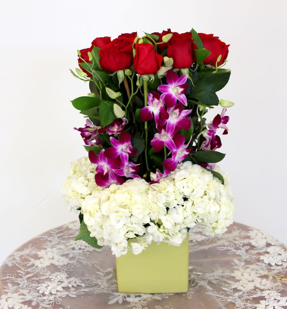 Roses and Hydrangeas - Orchids, hydrangeas and roses in a tall arrangement. 
