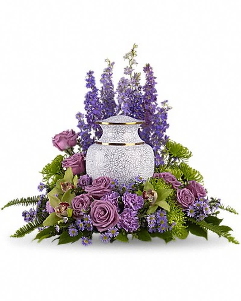 Meadows of Memories Cremation Tribute - Soft lavender and green blooms to surround the urn, like a peaceful, contemplative garden. A subdued assortment of flowers such as lavender larkspur, roses and asters are grouped beautifully with the rich greens of cymbidium orchids, chrysanthemums, English boxwood and sword fern.Please note: Arrangement does not include urn.