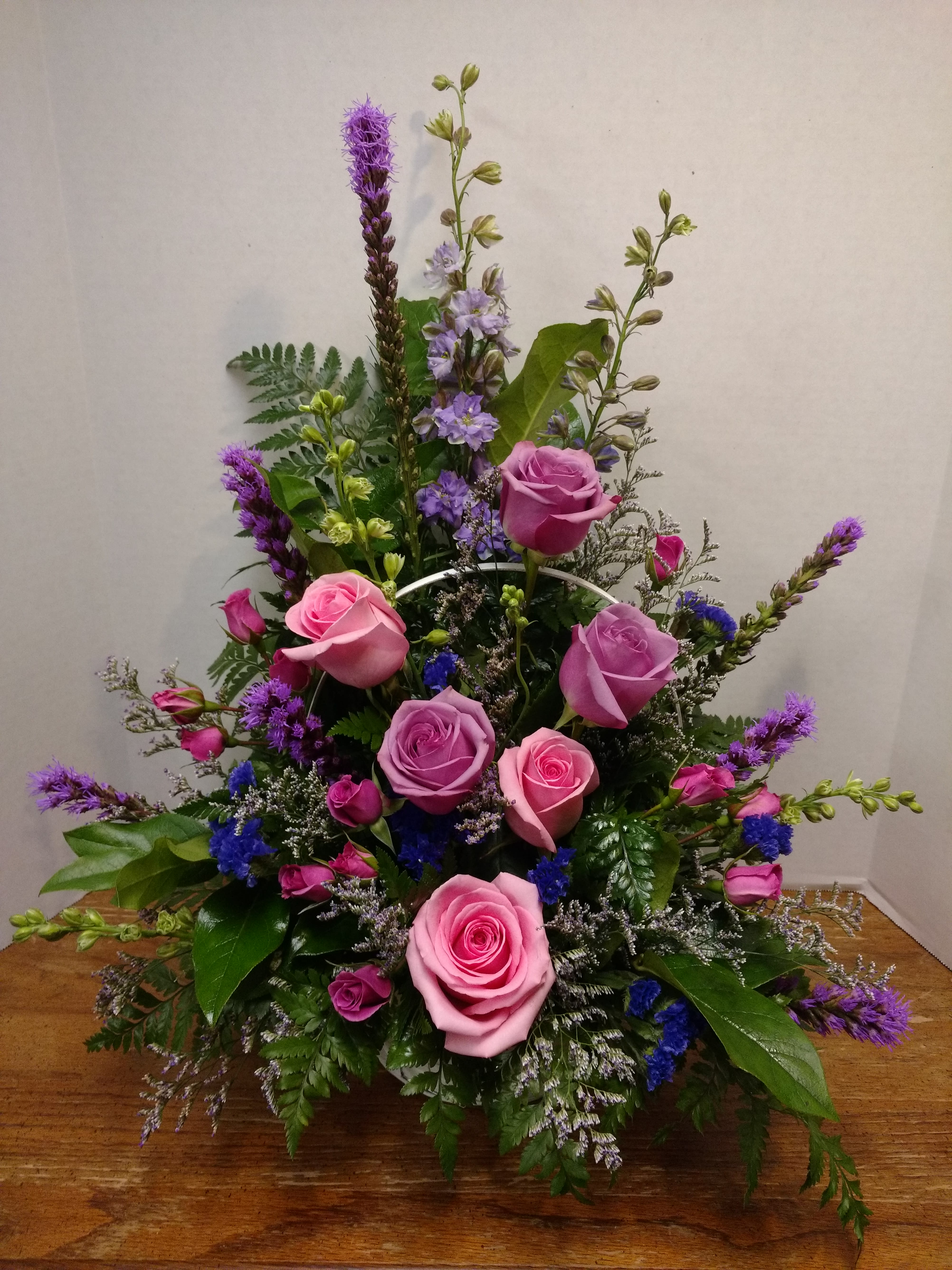 Memorable - A memorable basket arrangement with all the right sentiment.. Featuring liatrice,  larkspur, spray roses, roses, lemonium and lush greens. Suitable for a funeral service or home delivery