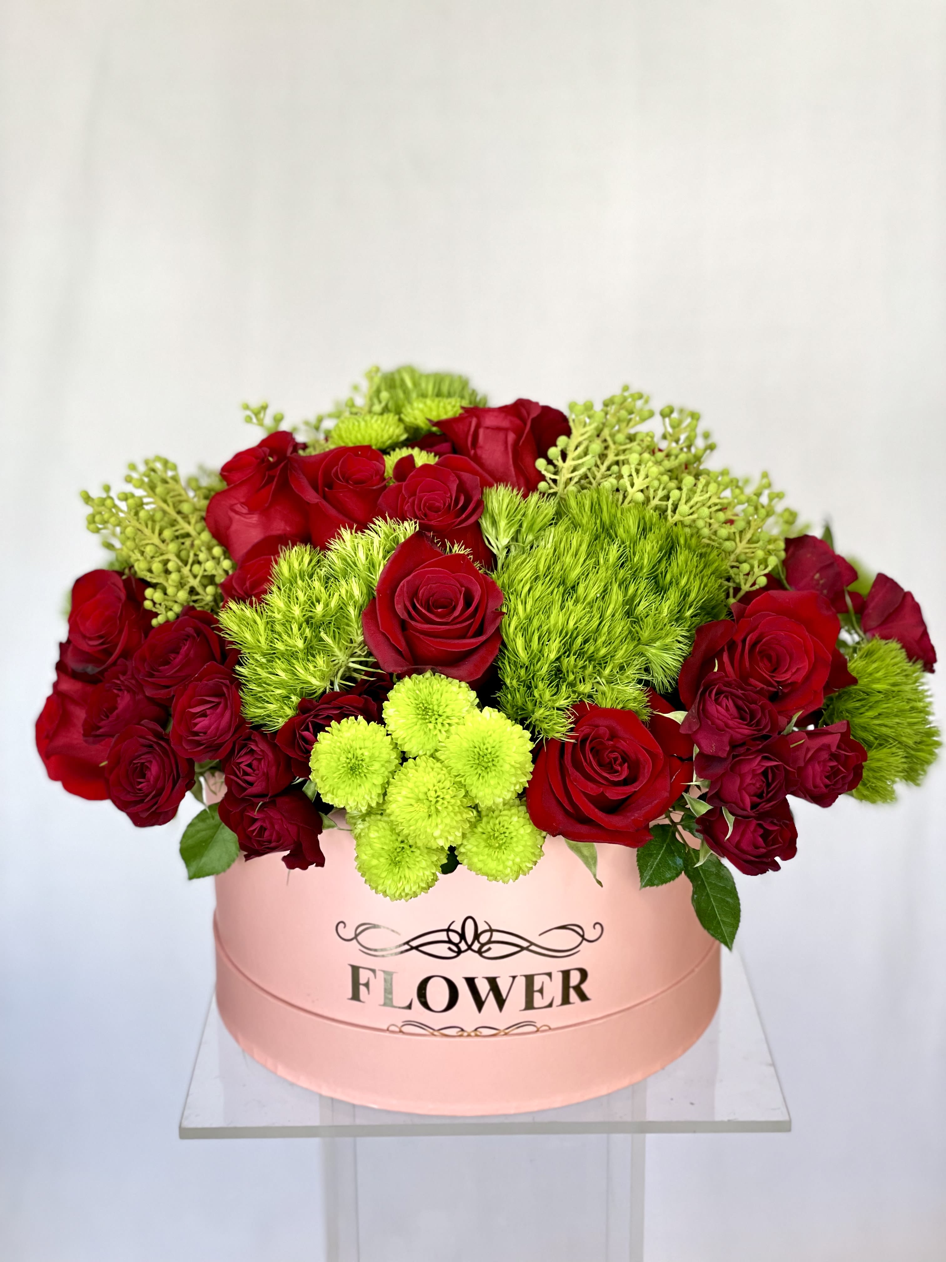 Fields of Europe Fields of Europe - Red Roses, Green Button, with added greenery in a pink hat box.