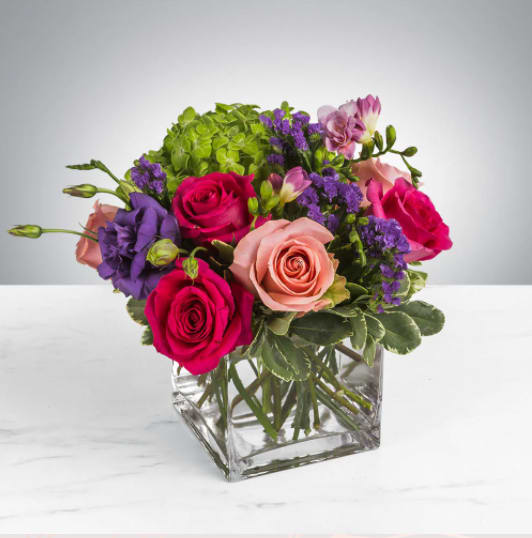 Spring Fling by BloomNation™ Spring Fling by BloomNation™ - This arrangement includes hot pink roses, pink roses, green hydrangea, freesia, lisianthus, purple statice. Spring Fling by BloomNation™ is a great gift for a birthday, get well, or just because. APPROXIMATE DIMENSIONS: 12" H X 12" W