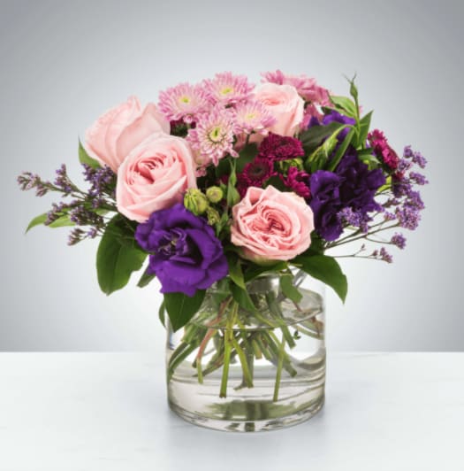 Coming Home by BloomNation™ Coming Home by BloomNation™ - A selection of pink and purple flowers come together in an eye-pleasing arrangement. This arrangement makes a great gift for Mother's Day, Women's Day, or as a thinking of you present. Approximate Dimensions: 10''D x 10''H
