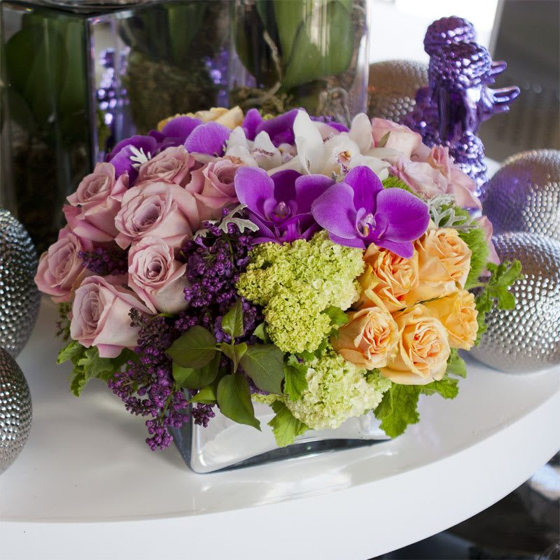 Luscious Lilacs Luscious Lilacs - Lush pave of purple lilac, green viburnum, pink and peach roses, and white and fuschia Phalaenopsis orchids, and white cymbidium orchids in an updated traditional design.