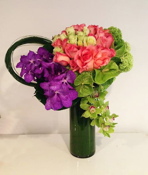 Mademoiselle - This tall and glamorous arrangement is bursting with colors from roses, cymbidium orchids, vanda orchids, and anthuriums. A perfect statement piece to impress!