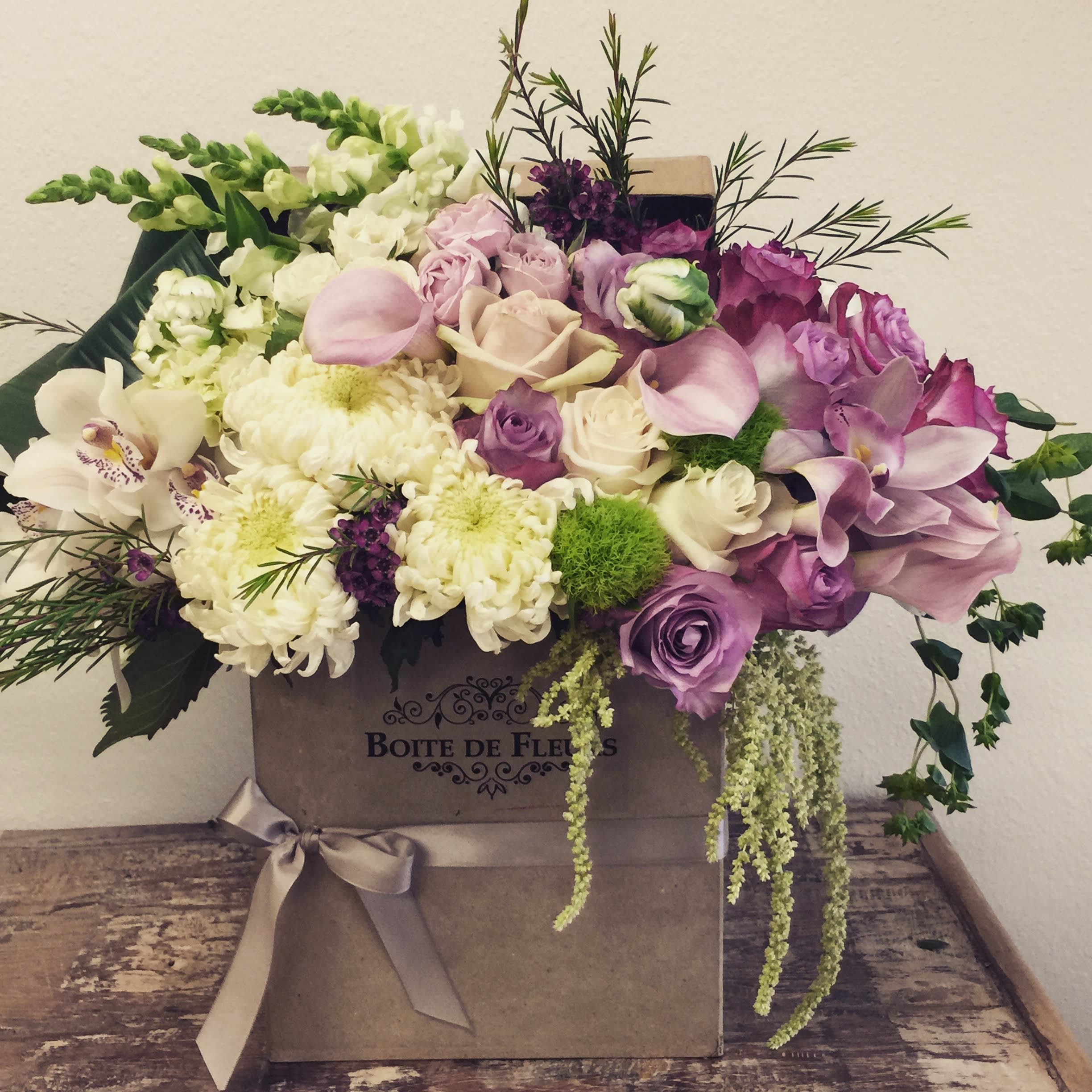 Timeless Floral Mix Timeless Floral Mix - Gold Box with an arrangement of mixed flowers in white and purple, accented with green