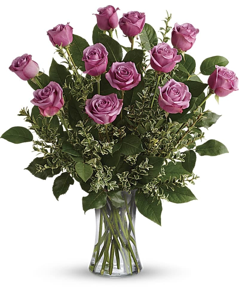 Hey Gorgeous Bouquet - A gorgeous greeting for any occasion this lovely lavender bouquet features one dozen radiant roses with lush greens in a classic glass vase. This gorgeous bouquet includes 12 lavender roses oregonia and lemon leaf. Delivered in a glass gathering vase.