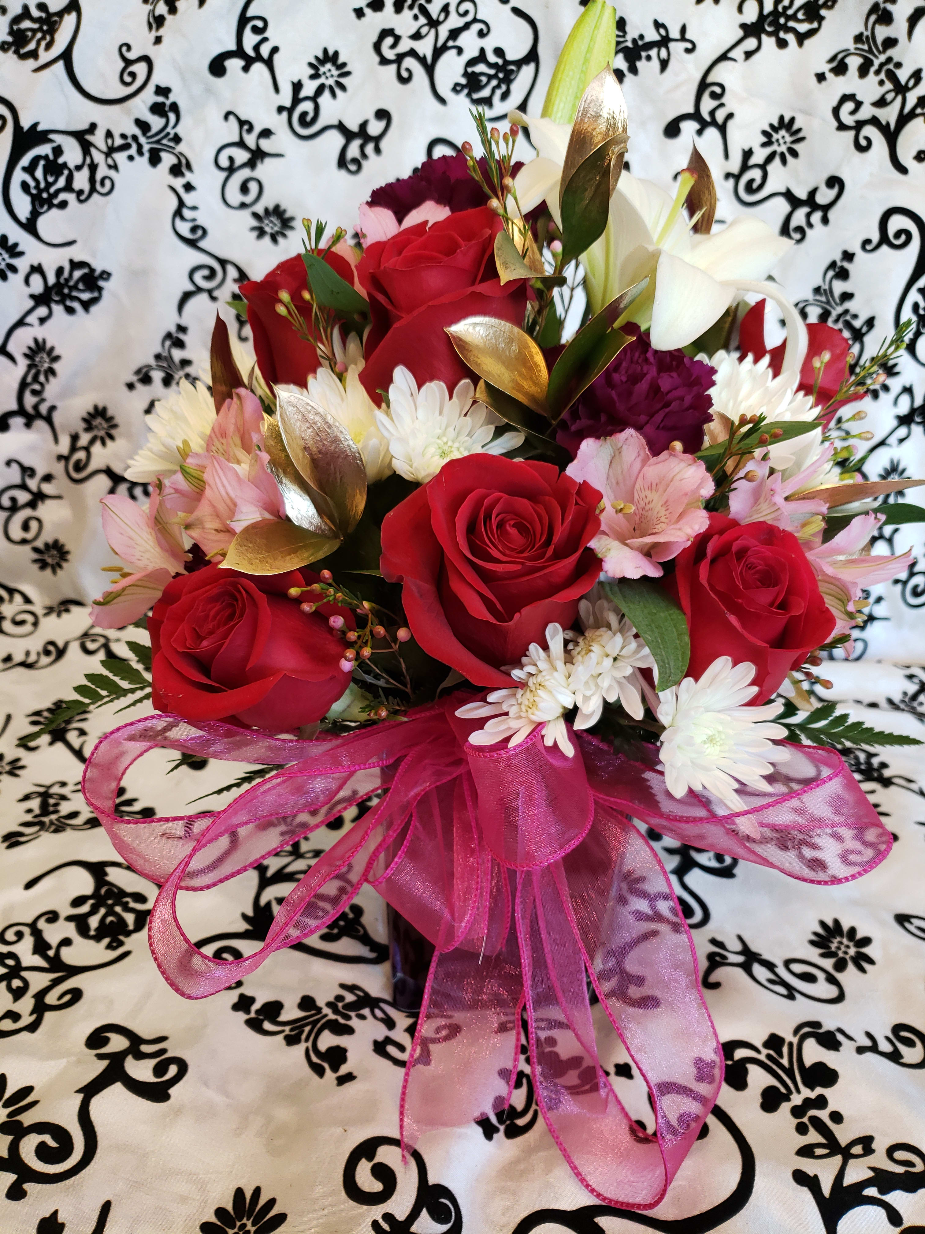 PINK, RED and WHITE Flowers inside a Cube (Designer Choice) PINK, RED and WHITE Flowers inside a Cube (Designer Choice) - Colorful red and pink and white flowers all arranged in a cube. Designer choice with only pink, red and white flowers. We will add Roses, cushion, carnations and lilies.