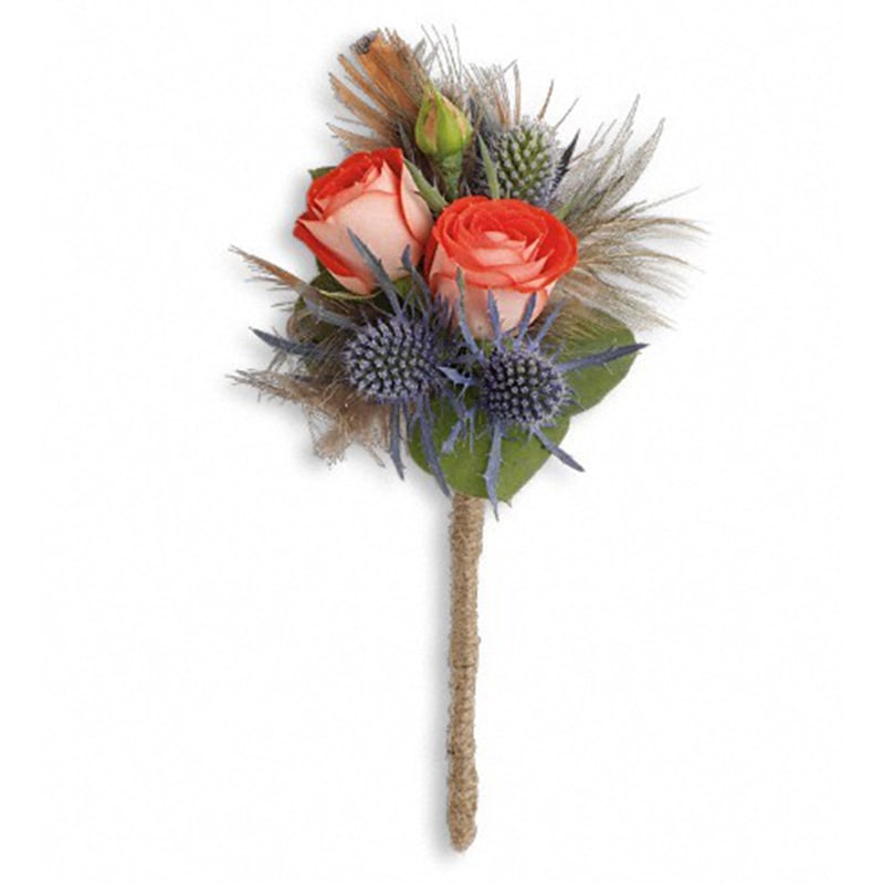 Boho Dreams Boutonniere Boho Dreams Boutonniere - This exotic mix of blue eryngium and pheasant feathers is sure to turn heads. Orange spray roses, blue eryngium and seeded eucalyptus with pheasant feathers. Approximately 2 1/2" W x 6" H Product ID: TPR03-1A