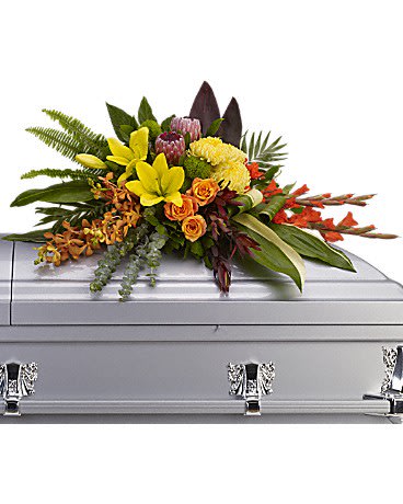  Island Memories Casket Spray - Graceful and fresh, this tropical-influenced spray sheds light on memories that will be forever treasured. Splashed with color and grounded with earth tones, it lends comfort and hope to any memorial.  Yellow asiatic lilies with orange orchids and roses, red gladioli, pink protea and yellow chrysanthemums are draped across the casket amidst radiating ferns, greens and leaves.  Approximately 40&quot; W x 22 1/2&quot; H
