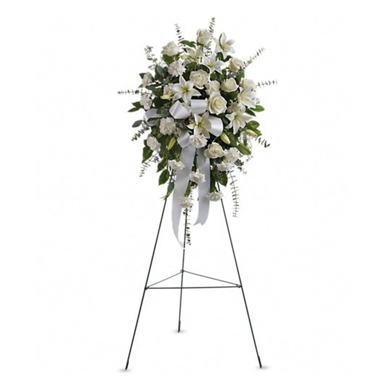  Sentiments of Serenity Spray - Beautifully simple, this lovely spray of white roses, lilies and carnations decorated with white satin ribbon is a tasteful way to express your sympathy.  The elegant spray includes white roses, white Asiatic lilies and white carnations, accented with assorted greenery.