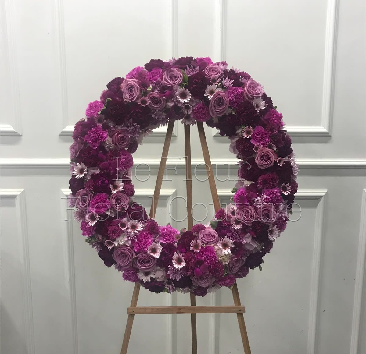 Deepest Faith Sympathy Wreath - Gorgeous blooms such as lavender roses and carnations, and chrysanthemums of lavender and deep purple create a beautiful sympathy wreath for a funeral or memorial service.